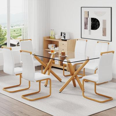 Ivy Bronx Chic 7-piece Dining Set: 0.39'' Tempered Glass Table, Wooden Metal Legs & White Pu Leather Chairs in Dining Tables & Sets