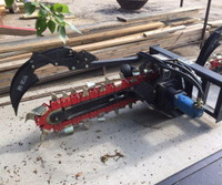 SKID STEER TRENCHER AND AUGER DISCHARGE ATTACHMENT