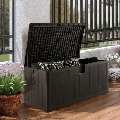 This large 130-gallon weather-resistant storage bench features ample space, a lockable lid, side han...