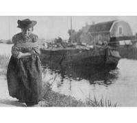 Buyenlarge A Older Dutch Woman Has a Bustle Around Her Chest as She Pulls a Barge Down a Canal - Photograph Print