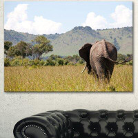 Design Art 'Retreating Elephant in Savannah' Photographic Print on Wrapped Canvas