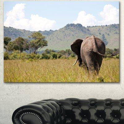 Design Art 'Retreating Elephant in Savannah' Photographic Print on Wrapped Canvas in Arts & Collectibles