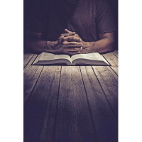 Ebern Designs Cowyn Man Praying On A Wooden Table With An Open Bible On Canvas by Javier_Art_Photography Photograph
