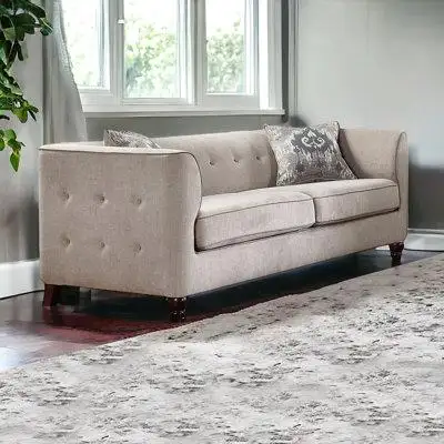 Add an air of fashion to your space with this fabulous 78 tan velvet and black sofa with two toss pi...
