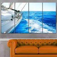 Design Art 'White Sailing Yacht in Blue Sea' 4 Piece Photographic Print on Wrapped Canvas Set