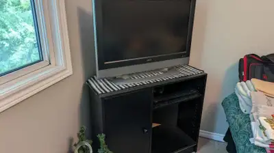 ONLINE AUCTION: Black TV Stand and TV